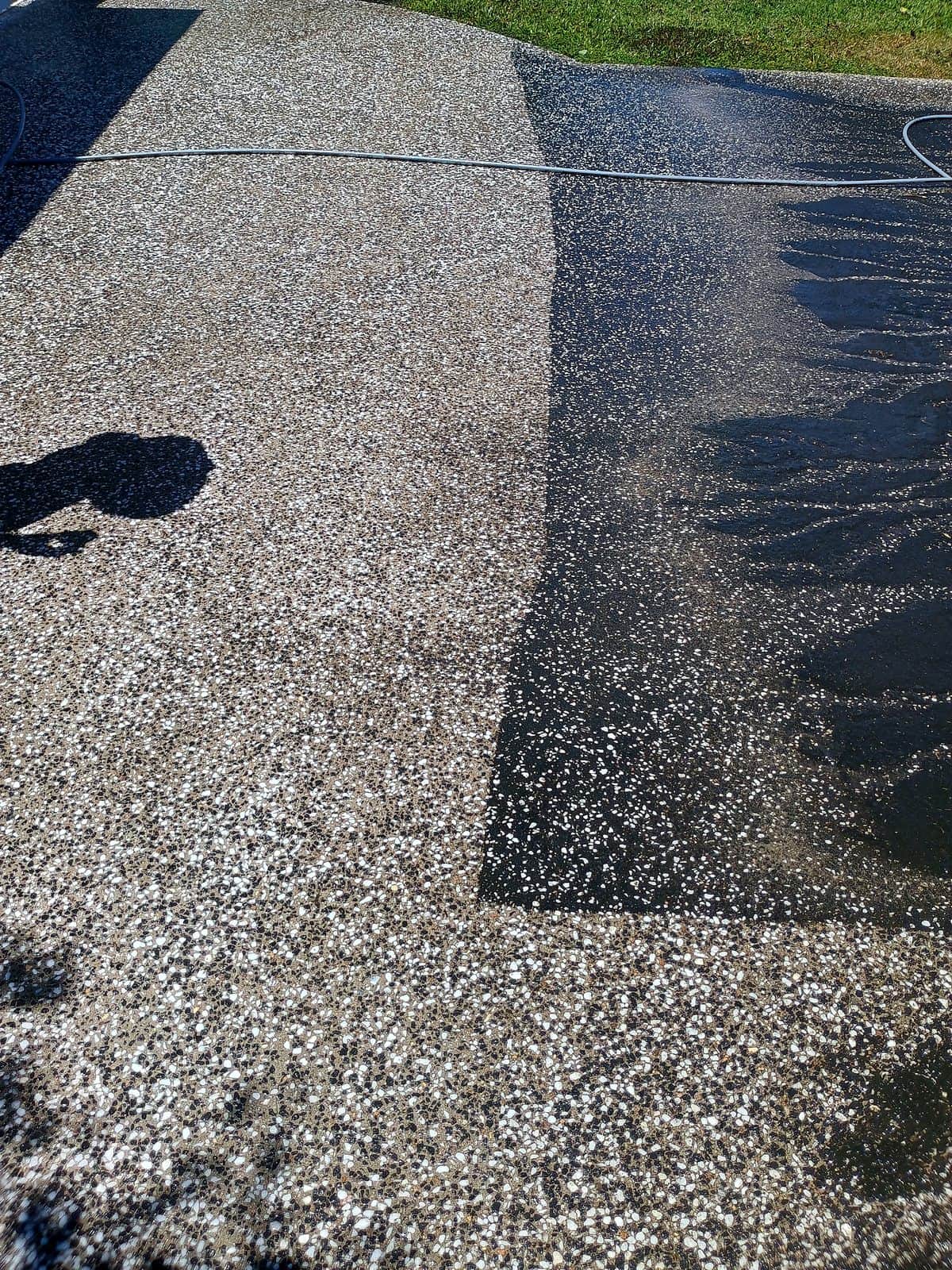 Concrete driveway in Edmonton half pressure cleaned, dirty and clean sections side by side